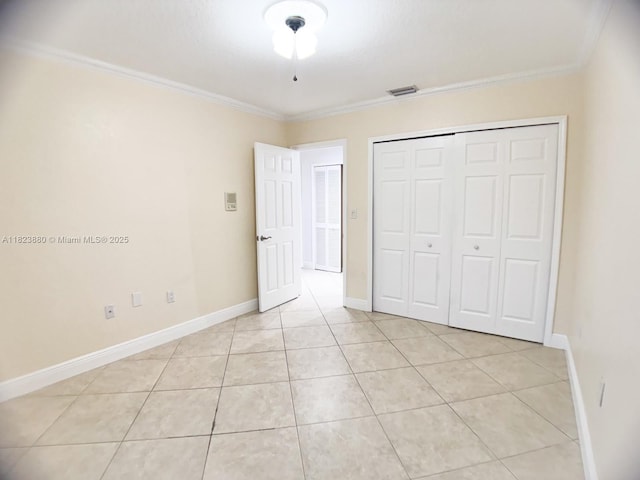 14332 SW 38th Ter, Miami, FL 33175 - unfurnished bedroom with crown molding, light tile patterned floors, and a closet
