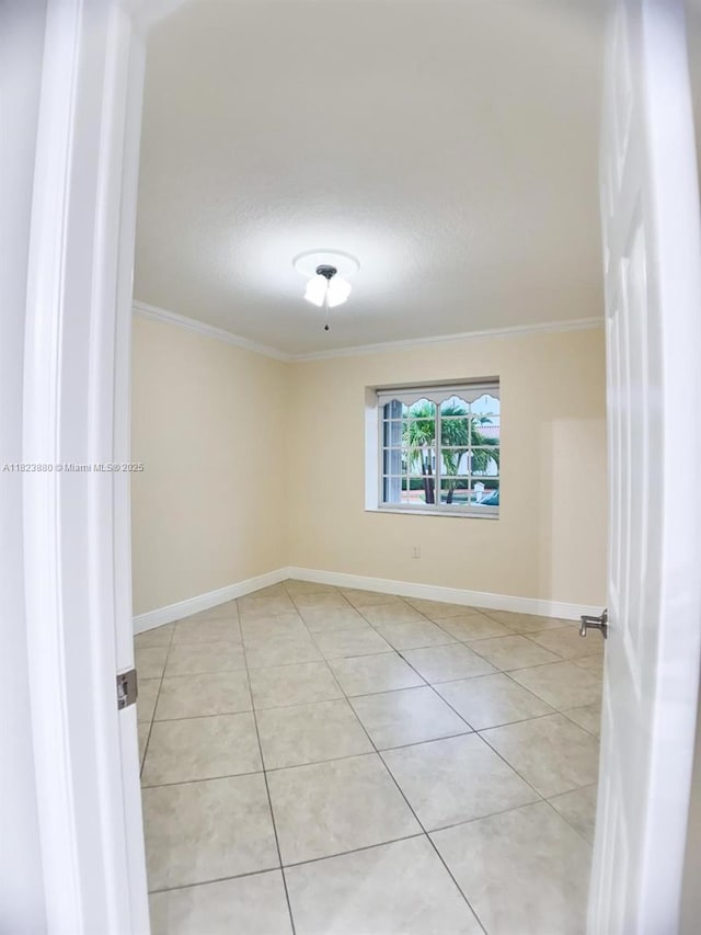 14332 SW 38th Ter, Miami, FL 33175 - empty room with crown molding and light tile patterned flooring