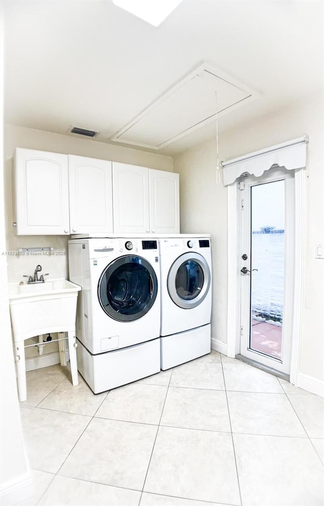 14332 SW 38th Ter, Miami, FL 33175 - washroom featuring cabinet space, independent washer and dryer, attic access, and light tile patterned flooring
