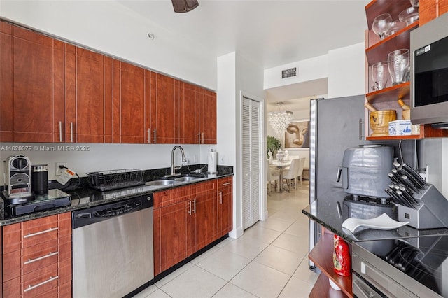 2425 SW 27th Ave Unit 705, Miami, FL 33145 - kitchen with stainless steel appliances, dark stone counters, light tile patterned flooring, and open shelves