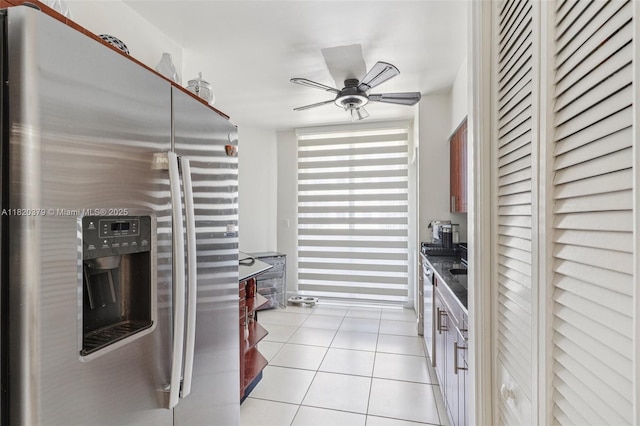 2425 SW 27th Ave Unit 705, Miami, FL 33145 - kitchen with stainless steel appliances, light tile patterned floors, a ceiling fan, and dark countertops