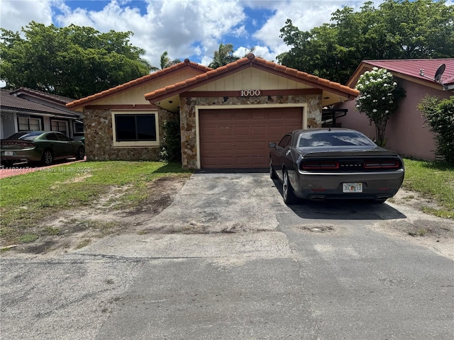 1000 SW 136th Pl, Miami, FL 33184 - view of front of house featuring stone siding, driveway, a garage, and a tile roof