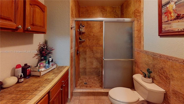 1000 SW 136th Pl, Miami, FL 33184 - full bathroom featuring a stall shower, vanity, tile patterned floors, and a wainscoted wall
