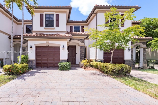 3324 W 90, Hialeah, FL 33018 - view of front of home with stucco siding, stone siding, an attached garage, a tile roof, and decorative driveway