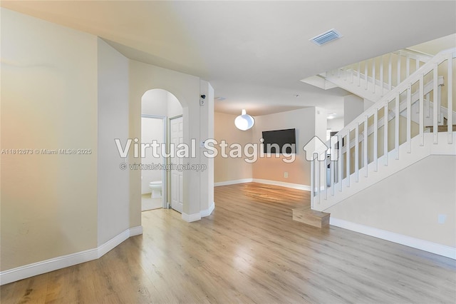 3324 W 90, Hialeah, FL 33018 - unfurnished room with arched walkways, light wood-style flooring, and stairs