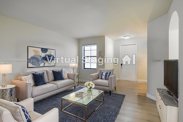 3324 W 90, Hialeah, FL 33018 - living room featuring light wood-style floors and arched walkways