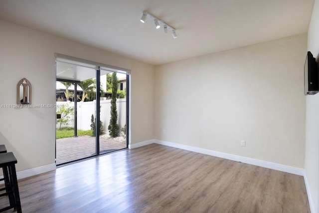 3324 W 90, Hialeah, FL 33018 - unfurnished room featuring wood finished floors and rail lighting