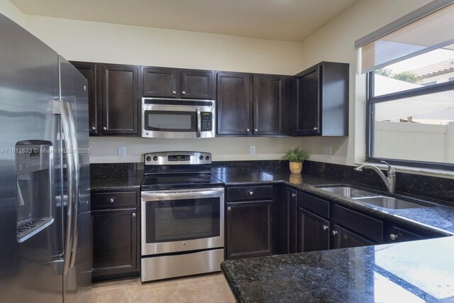 3324 W 90, Hialeah, FL 33018 - kitchen featuring stainless steel appliances, dark stone counters, and light tile patterned flooring