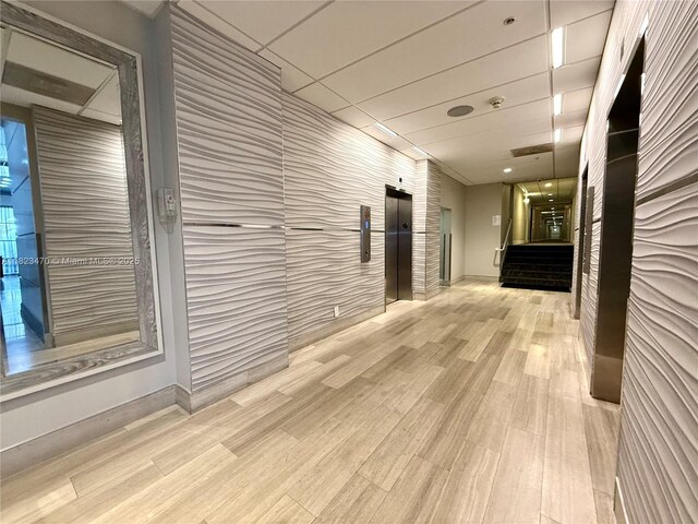 19390 Collins Ave Unit 224, Sunny Isles Beach, FL 33160 - hallway featuring elevator and wood finished floors