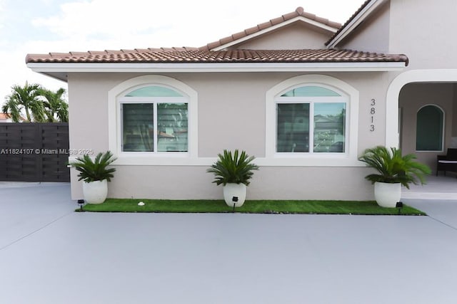 3813 SW 149th Pl, Miami, FL 33185 - view of front of house with stucco siding, a tile roof, and a patio area