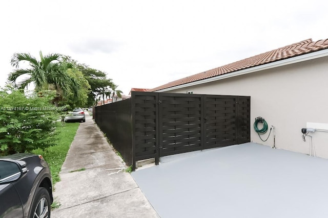 3813 SW 149th Pl, Miami, FL 33185 - view of side of property featuring stucco siding and a gate