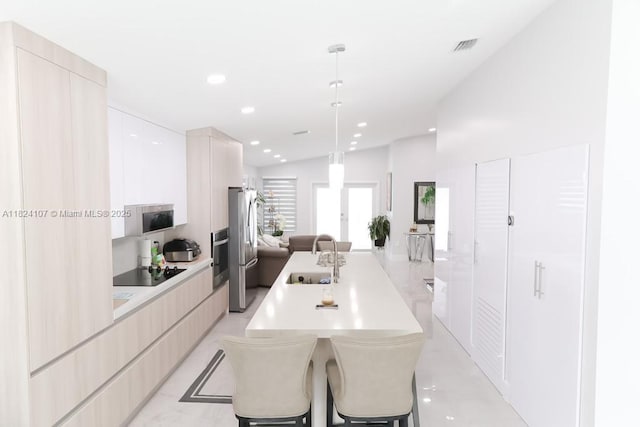 3813 SW 149th Pl, Miami, FL 33185 - kitchen with modern cabinets, open floor plan, appliances with stainless steel finishes, light countertops, and recessed lighting
