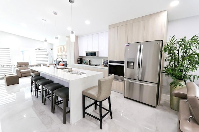 3813 SW 149th Pl, Miami, FL 33185 - kitchen featuring appliances with stainless steel finishes, modern cabinets, a kitchen breakfast bar, light countertops, and light marble finish flooring