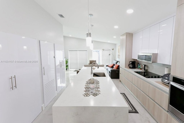 3813 SW 149th Pl, Miami, FL 33185 - kitchen featuring modern cabinets, black electric cooktop, a kitchen island with sink, open floor plan, and recessed lighting
