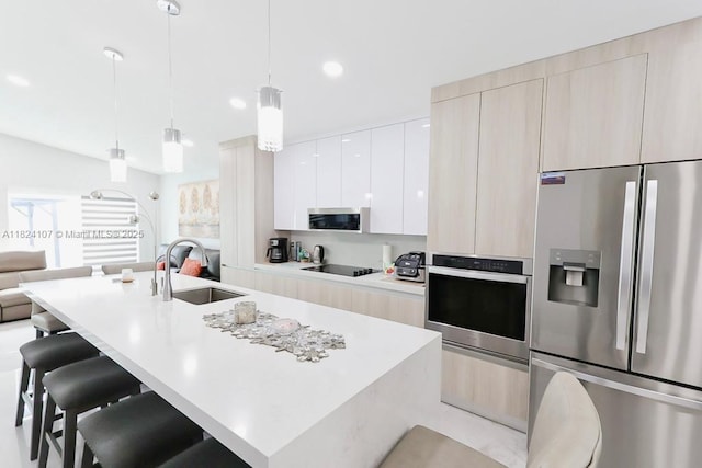 3813 SW 149th Pl, Miami, FL 33185 - kitchen with stainless steel appliances, modern cabinets, a breakfast bar, and a center island with sink