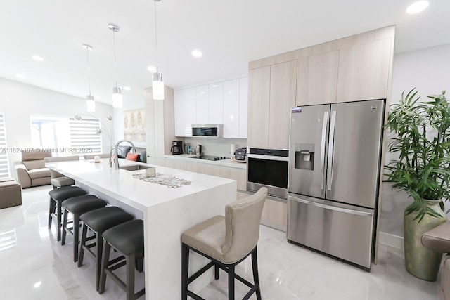 3813 SW 149th Pl, Miami, FL 33185 - kitchen with stainless steel appliances, modern cabinets, a breakfast bar, a center island with sink, and light countertops