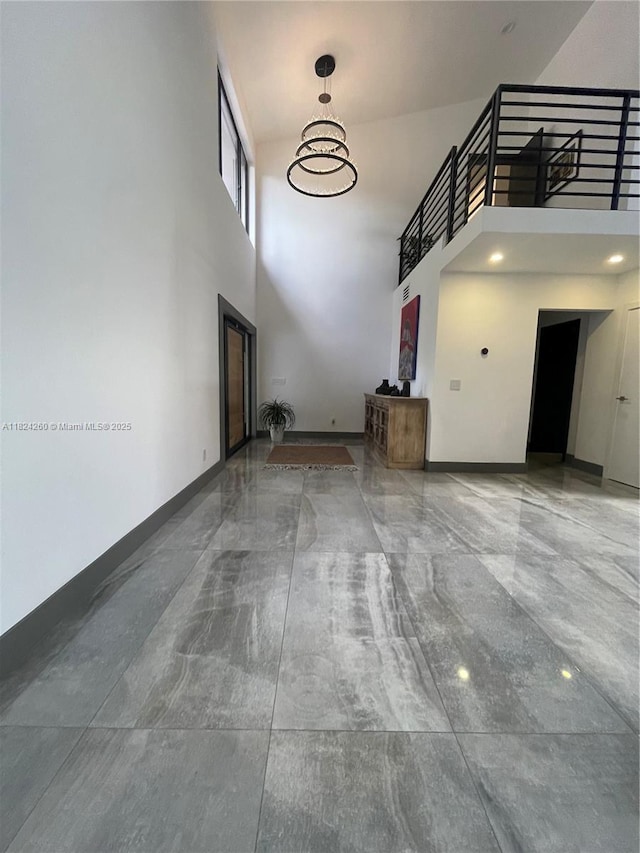 5811 SW 33rd Ter, Hollywood, FL 33312 - unfurnished living room with a high ceiling and a chandelier