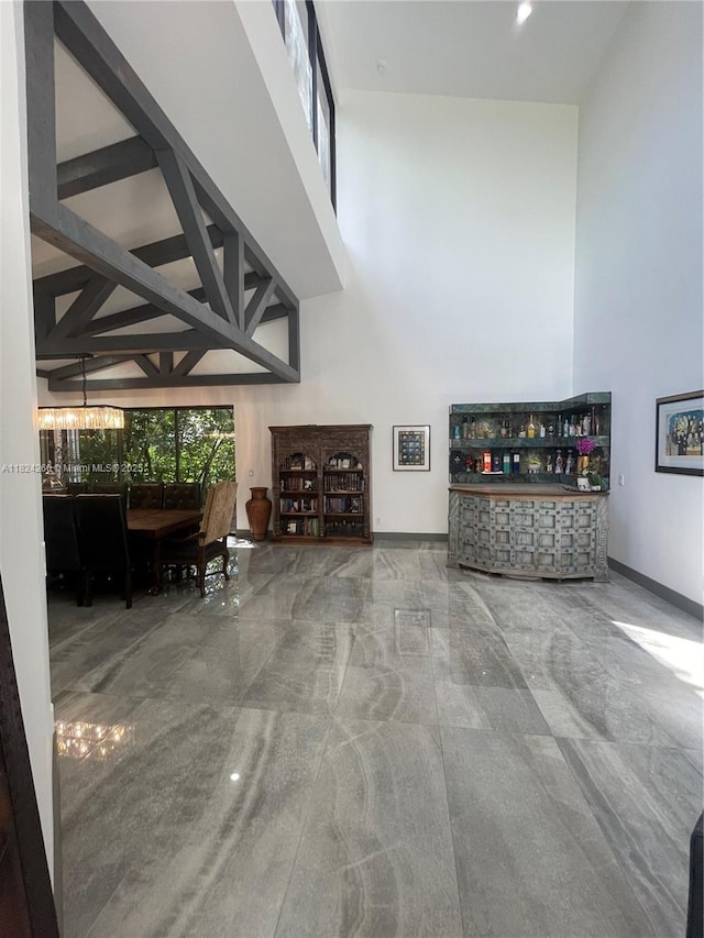 5811 SW 33rd Ter, Hollywood, FL 33312 - living area with a high ceiling, a dry bar, and a chandelier