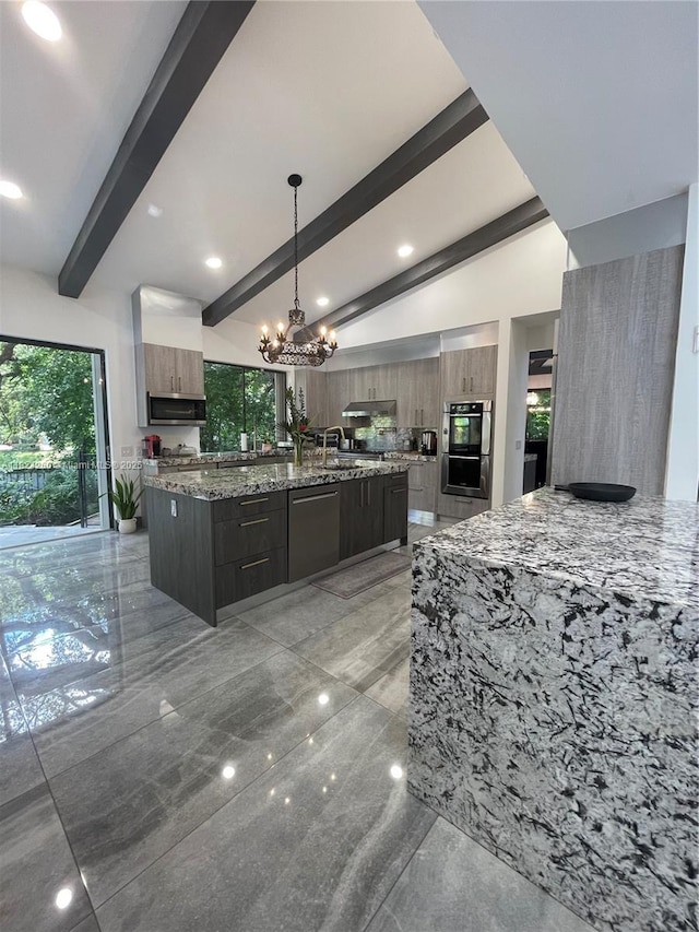 5811 SW 33rd Ter, Hollywood, FL 33312 - kitchen with modern cabinets, stainless steel appliances, a chandelier, a spacious island, and light stone countertops