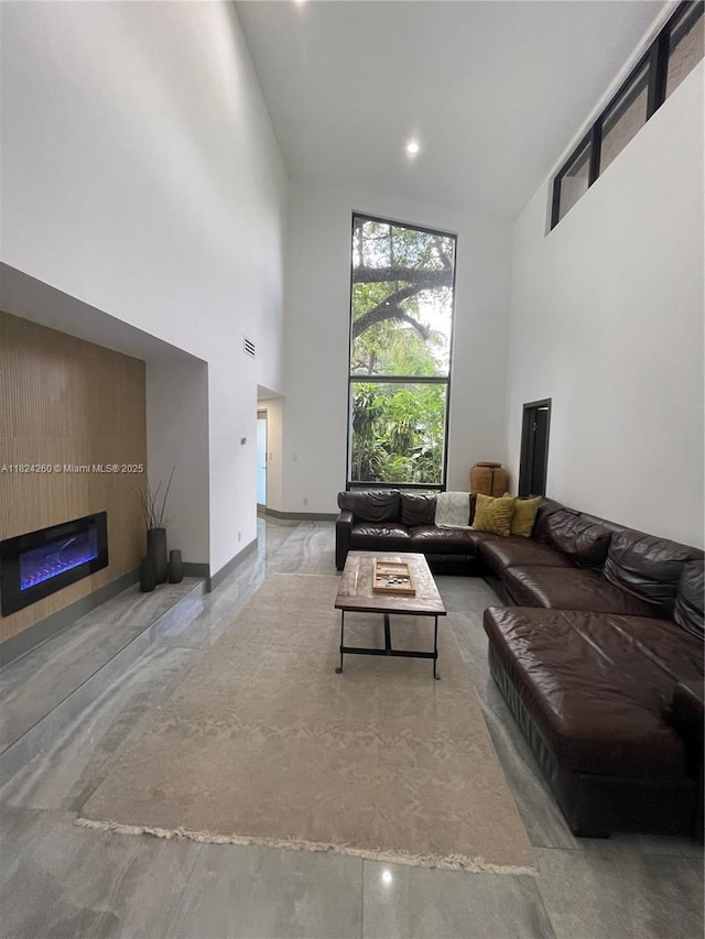 5811 SW 33rd Ter, Hollywood, FL 33312 - living area featuring a towering ceiling and a glass covered fireplace
