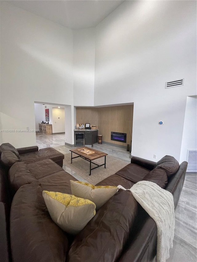 5811 SW 33rd Ter, Hollywood, FL 33312 - living room featuring a towering ceiling, a fireplace, and wine cooler