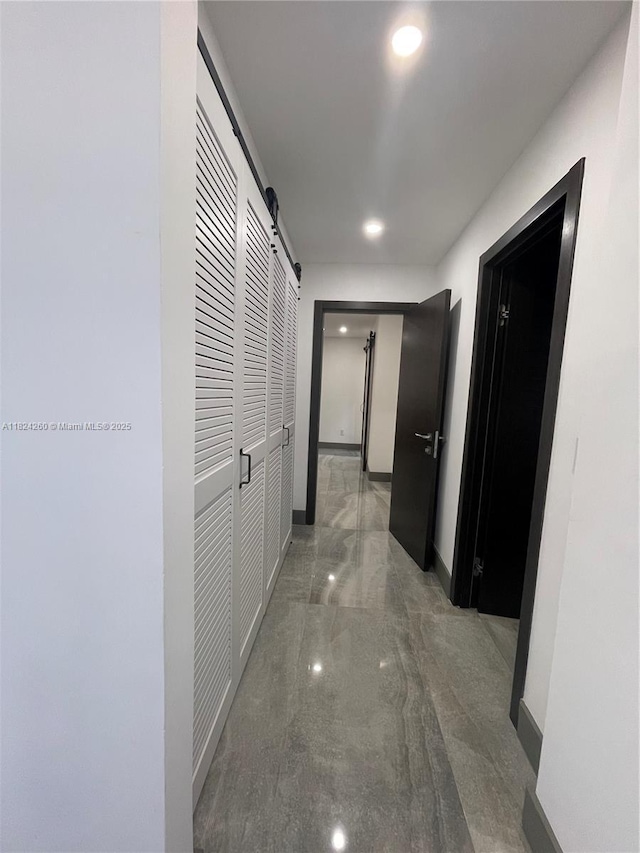5811 SW 33rd Ter, Hollywood, FL 33312 - hallway featuring a barn door, marble finish flooring, and recessed lighting