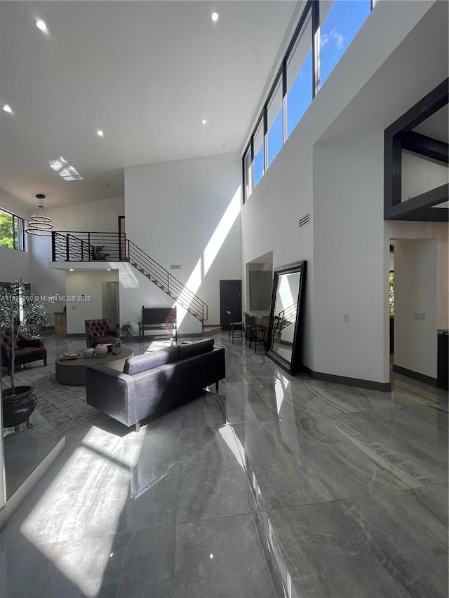 5811 SW 33rd Ter, Hollywood, FL 33312 - living room featuring a towering ceiling, marble tiled floors, recessed lighting, and stairs