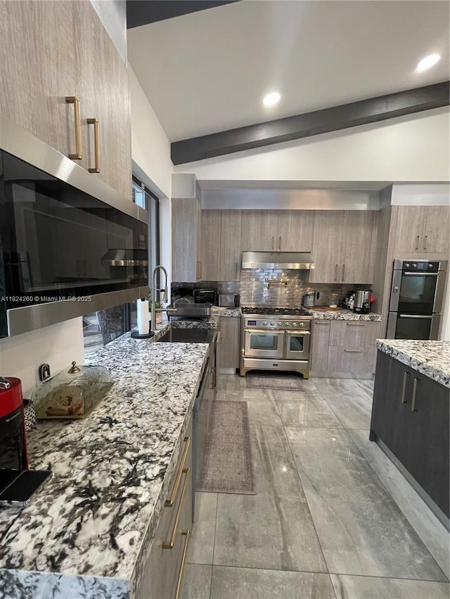 5811 SW 33rd Ter, Hollywood, FL 33312 - kitchen with stainless steel appliances, under cabinet range hood, modern cabinets, light stone counters, and tasteful backsplash