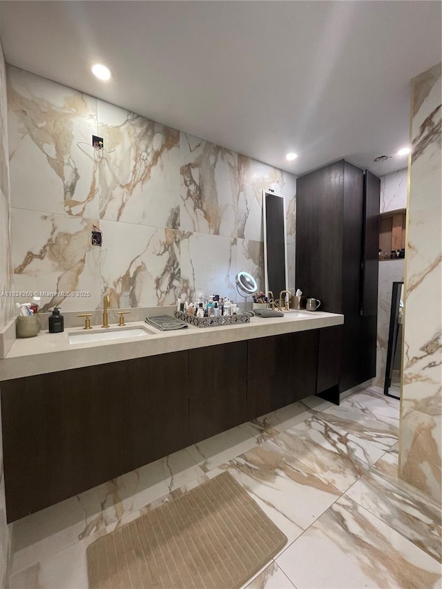 5811 SW 33rd Ter, Hollywood, FL 33312 - bathroom with double vanity, marble tiled flooring, recessed lighting, and stone wall