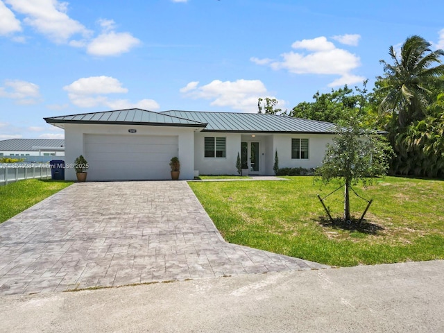 18100 SW 175th St, Miami, FL 33187 - ranch-style house with a standing seam roof, stucco siding, driveway, a front lawn, and a metal roof