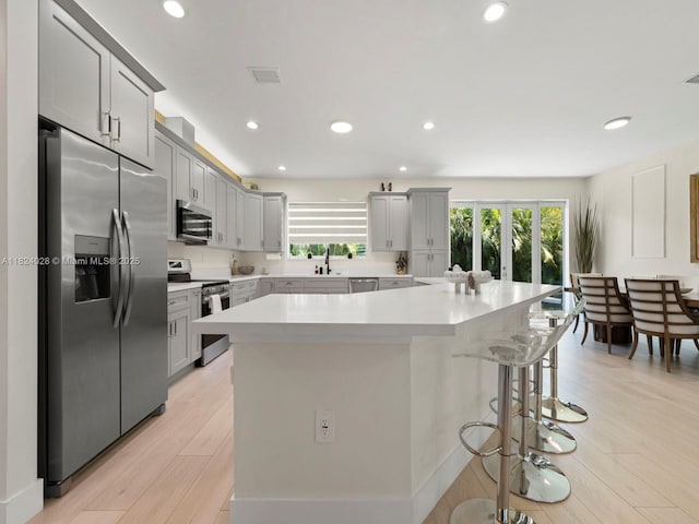 18100 SW 175th St, Miami, FL 33187 - kitchen with stainless steel appliances, healthy amount of natural light, light countertops, recessed lighting, and a kitchen bar