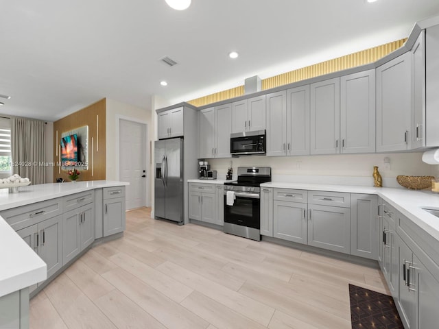 18100 SW 175th St, Miami, FL 33187 - kitchen with appliances with stainless steel finishes, gray cabinets, light countertops, light wood-style floors, and recessed lighting