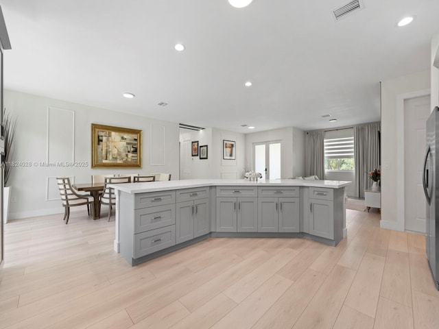 18100 SW 175th St, Miami, FL 33187 - kitchen featuring gray cabinetry, light countertops, light wood-style flooring, a kitchen island, and recessed lighting