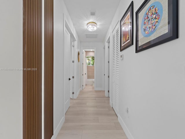 18100 SW 175th St, Miami, FL 33187 - hallway with light wood-type flooring and a chandelier