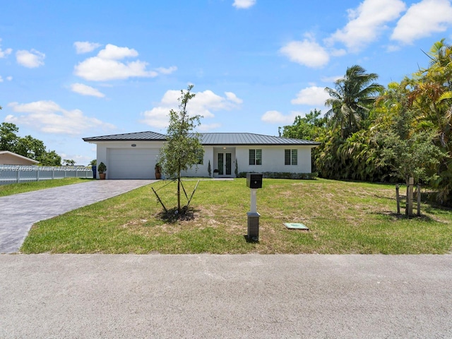 18100 SW 175th St, Miami, FL 33187 - single story home with french doors, decorative driveway, a standing seam roof, an attached garage, and stucco siding