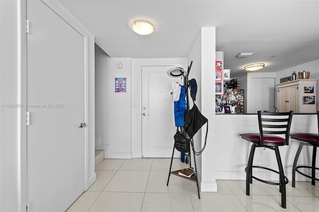 1861 NW S River Dr Unit Ph-01, Miami, FL 33125 - kitchen with tile patterned flooring and a kitchen breakfast bar