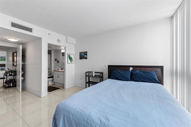 1861 NW S River Dr Unit Ph-01, Miami, FL 33125 - bedroom featuring light tile patterned floors, connected bathroom, and multiple windows