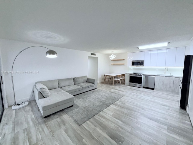 9352 S Belfort Cir Unit 109, Tamarac, FL 33321 - living room featuring light wood-style flooring