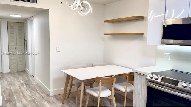 9352 S Belfort Cir Unit 109, Tamarac, FL 33321 - kitchen with stainless steel appliances, light wood-type flooring, and light countertops