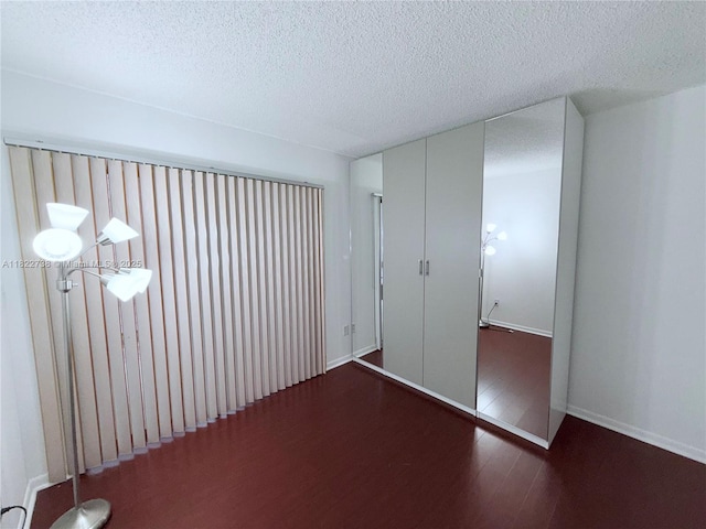 9352 S Belfort Cir Unit 109, Tamarac, FL 33321 - unfurnished bedroom featuring wood finished floors and a textured ceiling