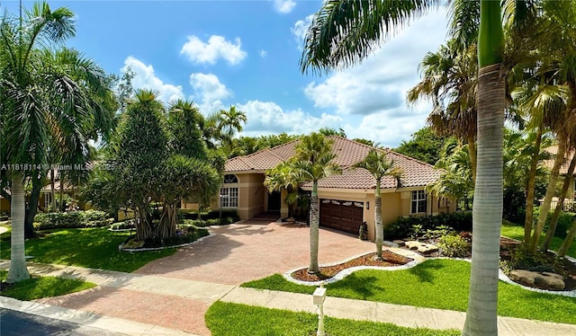 375 Sabal Way, Weston, FL 33326 - mediterranean / spanish-style home with a tiled roof, a garage, decorative driveway, stucco siding, and a front lawn