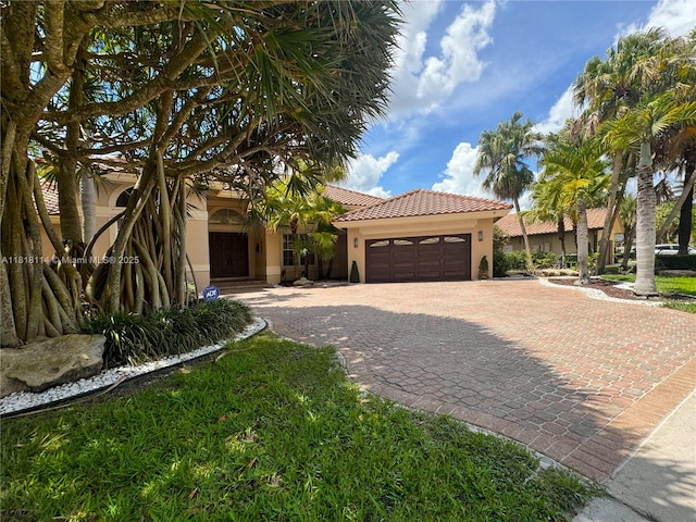 375 Sabal Way, Weston, FL 33326 - mediterranean / spanish house with stucco siding, a garage, decorative driveway, and a tile roof