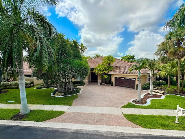 375 Sabal Way, Weston, FL 33326 - view of front of home featuring decorative driveway, an attached garage, a tile roof, stucco siding, and a front yard