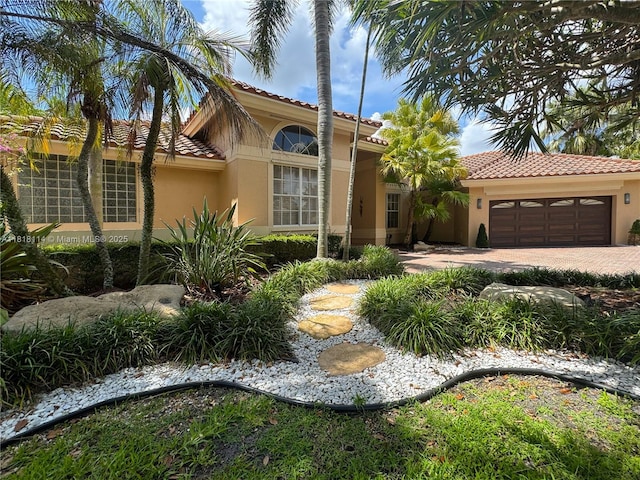 375 Sabal Way, Weston, FL 33326 - mediterranean / spanish-style home featuring stucco siding, a tile roof, an attached garage, and driveway