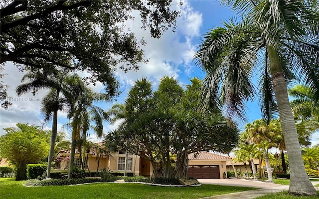 375 Sabal Way, Weston, FL 33326 - obstructed view of property featuring a garage, stucco siding, concrete driveway, and a front lawn
