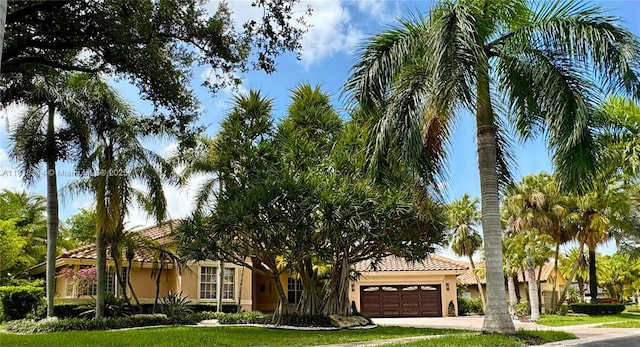 375 Sabal Way, Weston, FL 33326 - view of front of home with stucco siding, a garage, a tile roof, concrete driveway, and a front lawn