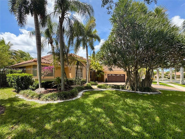 375 Sabal Way, Weston, FL 33326 - view of front of home with a garage, a tile roof, a front lawn, and stucco siding