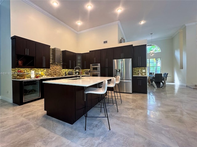 375 Sabal Way, Weston, FL 33326 - kitchen featuring stainless steel appliances, beverage cooler, light countertops, backsplash, and crown molding
