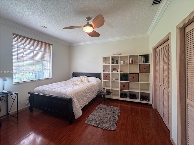 375 Sabal Way, Weston, FL 33326 - bedroom with wood finished floors, a textured ceiling, crown molding, a ceiling fan, and two closets