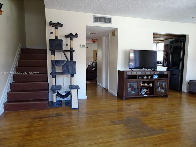 6680 SW 41st Pl Unit 32, Davie, FL 33314 - living room with wood finished floors, stairs, and a textured ceiling